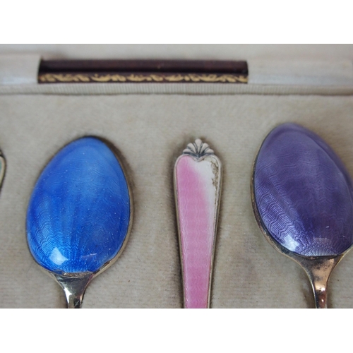 736 - A CASED SET OF SIX SILVER GILT AND ENAMEL COFFEE SPOONS