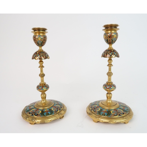 322 - FERDINAND BARBEDIENNE (1810-1892) A PAIR OF CHAMPLEVE ENAMEL CANDLESTICKS