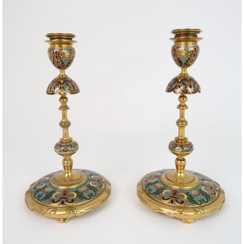 322 - FERDINAND BARBEDIENNE (1810-1892) A PAIR OF CHAMPLEVE ENAMEL CANDLESTICKS