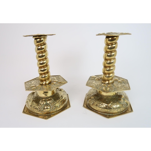 323 - A PAIR OF BRASS ARTS AND CRAFTS CANDLE HOLDERS