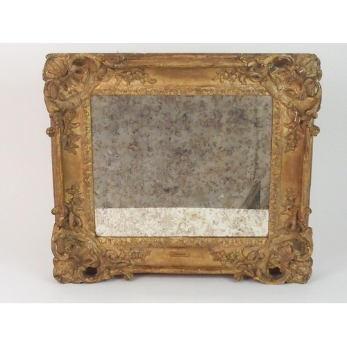 379 - AN EARLY CARVED FRAME WITH MIRROR PLATE