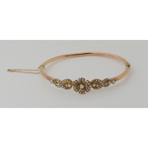 504 - A YELLOW METAL PEARL SET BANGLE