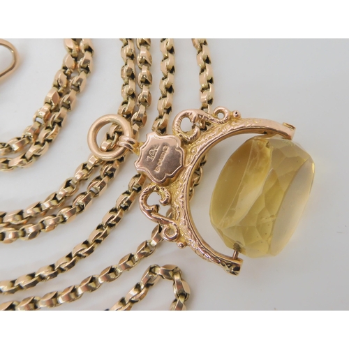 517 - A 9CT GOLD FANCY LINK GUARD CHAIN WITH A CITRINE FOB