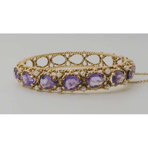 521 - A 14K GOLD AMETHYST AND PEARL BANGLE