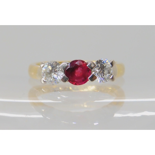 535 - AN 18CT GOLD RUBY AND DIAMOND THREE STONE RING