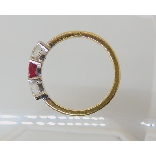 535 - AN 18CT GOLD RUBY AND DIAMOND THREE STONE RING