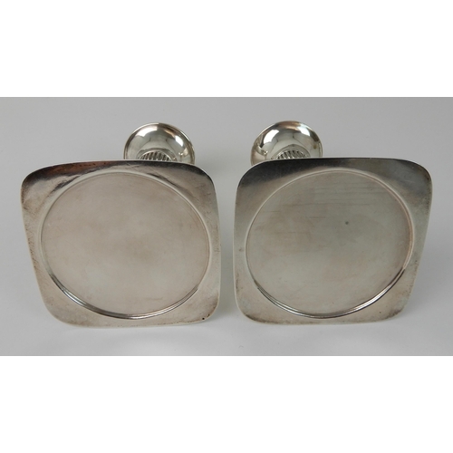 698 - A PAIR OF SILVER CANDLESTICKS