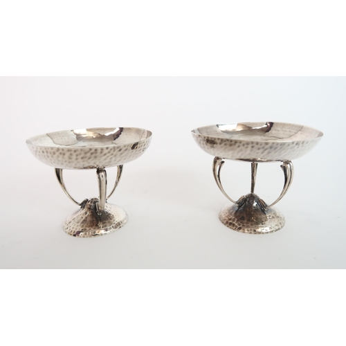 750 - A PAIR OF ARTS AND CRAFTS HAMMERED SILVER BON BON DISHES