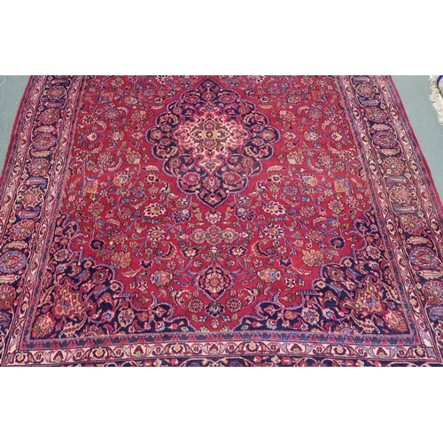 100 - A RED GROUND MESHED RUG