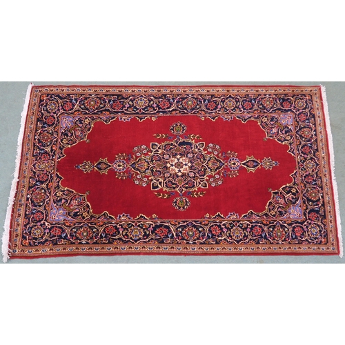 105 - A RED GROUND FINE KESHAN RUG