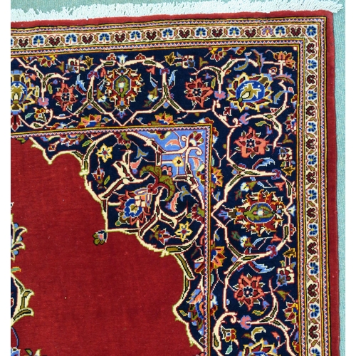 105 - A RED GROUND FINE KESHAN RUG