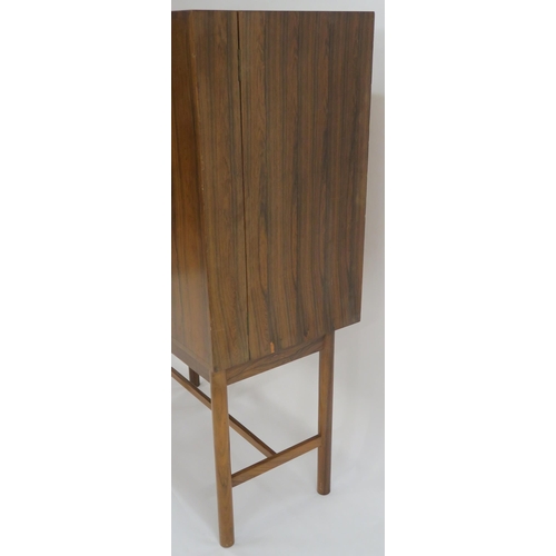 114 - A MID CENTURY ROSEWOOD COCKTAIL CABINET