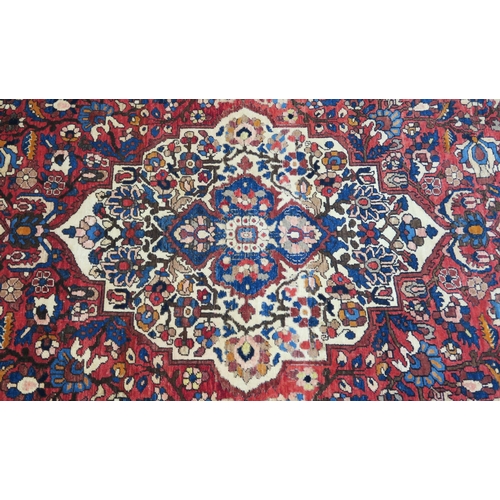 92 - A RED GROUND HAMADAN RUG