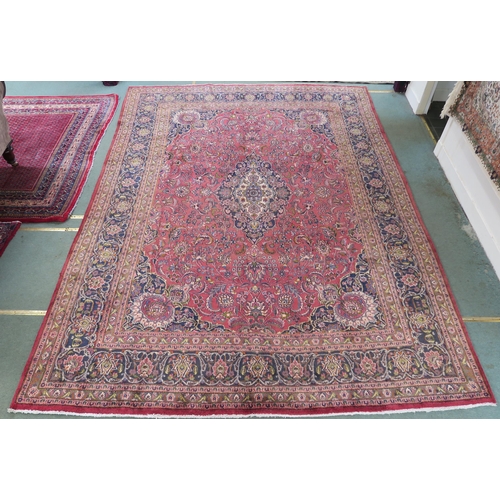 94 - A LARGE WASHED RED GROUND KESHAN RUG