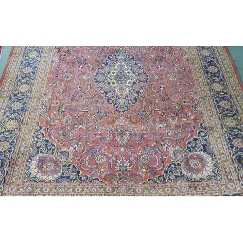 94 - A LARGE WASHED RED GROUND KESHAN RUG