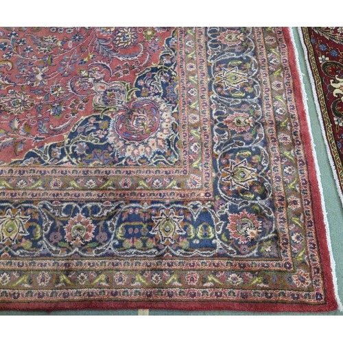 94 - A LARGE WASHED RED GROUND KESHAN RUG