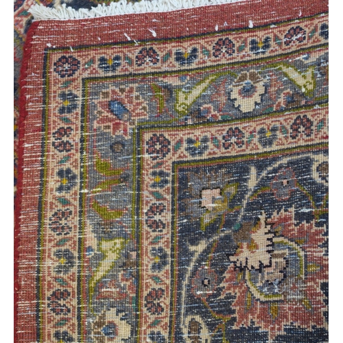 94 - A LARGE WASHED RED GROUND KESHAN RUG