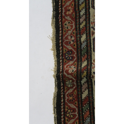 95 - A BLUE GROUND CAUCASIAN RUG