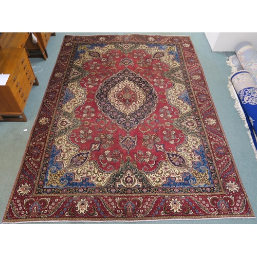 99 - A RED GROUND VINTAGE PERSIAN TABRIZ RUG