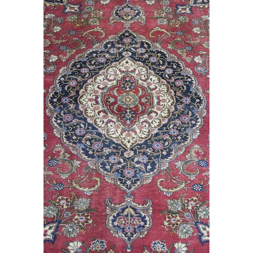 99 - A RED GROUND VINTAGE PERSIAN TABRIZ RUG