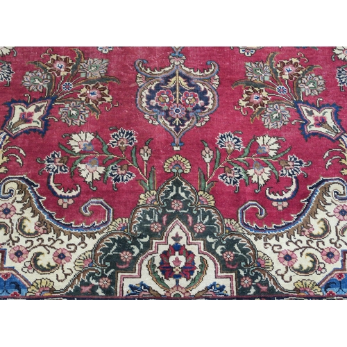 99 - A RED GROUND VINTAGE PERSIAN TABRIZ RUG