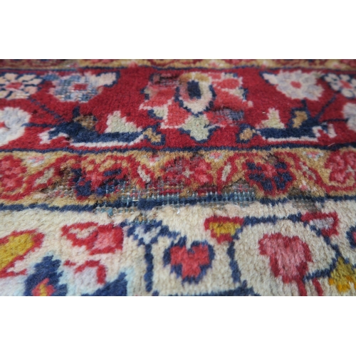 44 - A dark blue ground Persian rug with red central medallion, cream spandrels and red floral borders, 2... 