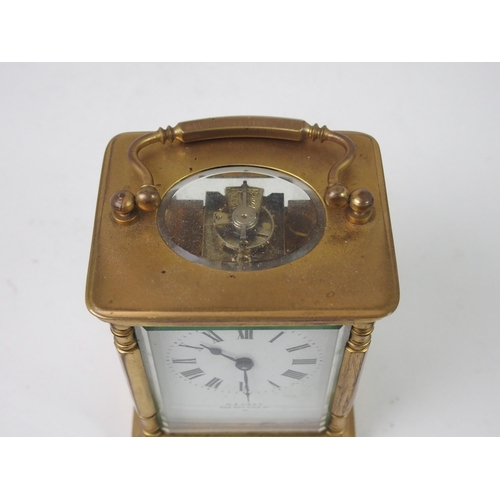 516 - A FRENCH BRASS AND GLASS CARRIAGE CLOCK