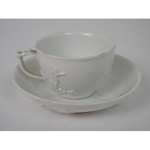 524 - A MEISSEN WHITE GLAZED CUP AND SAUCER