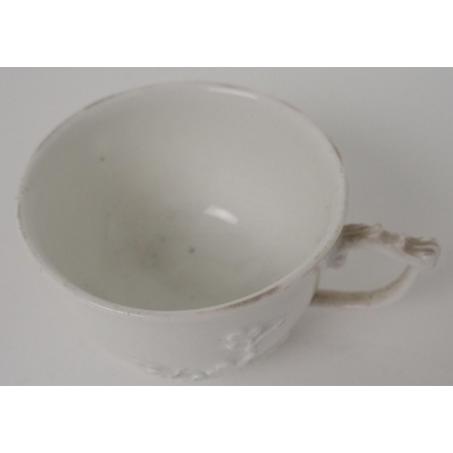 524 - A MEISSEN WHITE GLAZED CUP AND SAUCER