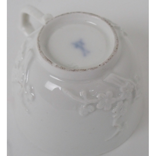 524 - A MEISSEN WHITE GLAZED CUP AND SAUCER