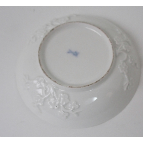 524 - A MEISSEN WHITE GLAZED CUP AND SAUCER