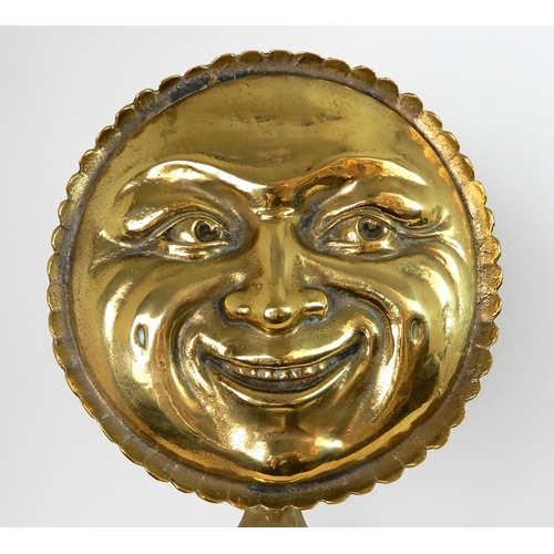 545 - A PAIR OF POLISHED BRASS SMILING MOON FACE FIRE DOGS