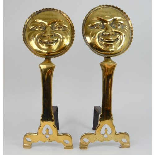 545 - A PAIR OF POLISHED BRASS SMILING MOON FACE FIRE DOGS