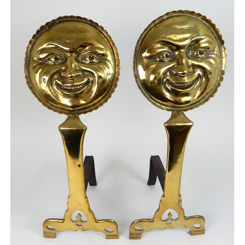 545 - A PAIR OF POLISHED BRASS SMILING MOON FACE FIRE DOGS