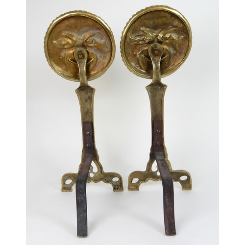 545 - A PAIR OF POLISHED BRASS SMILING MOON FACE FIRE DOGS