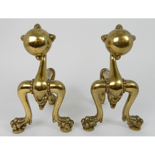 545 - A PAIR OF POLISHED BRASS SMILING MOON FACE FIRE DOGS