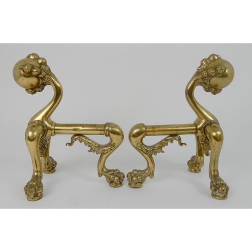 545 - A PAIR OF POLISHED BRASS SMILING MOON FACE FIRE DOGS