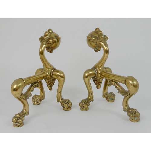 545 - A PAIR OF POLISHED BRASS SMILING MOON FACE FIRE DOGS