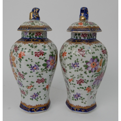 570 - A PAIR OF SAMSON JARS AND COVERS