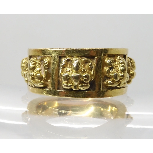 621 - A BRIGHT YELLOW METAL RING WITH PANELS OF DEITIES