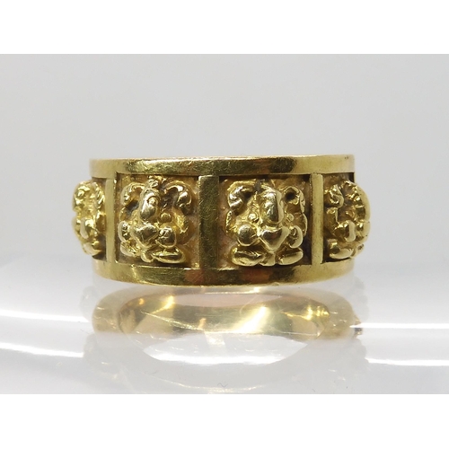 621 - A BRIGHT YELLOW METAL RING WITH PANELS OF DEITIES