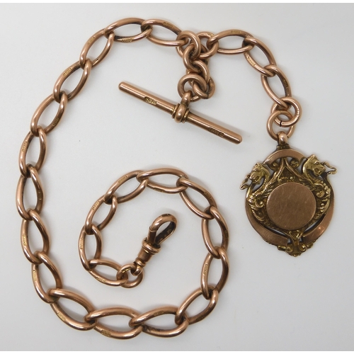 630 - A 9CT ROSE GOLD TAPERED FOB CHAIN WITH DRAGON MEDALLION