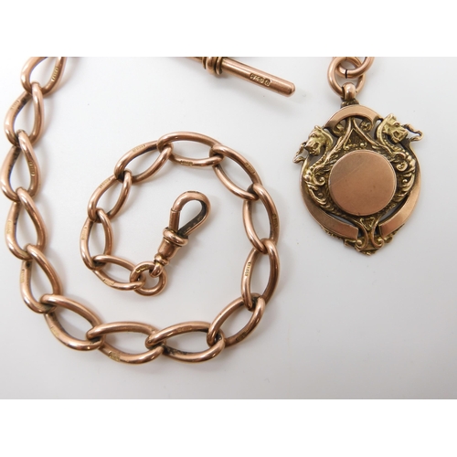 630 - A 9CT ROSE GOLD TAPERED FOB CHAIN WITH DRAGON MEDALLION