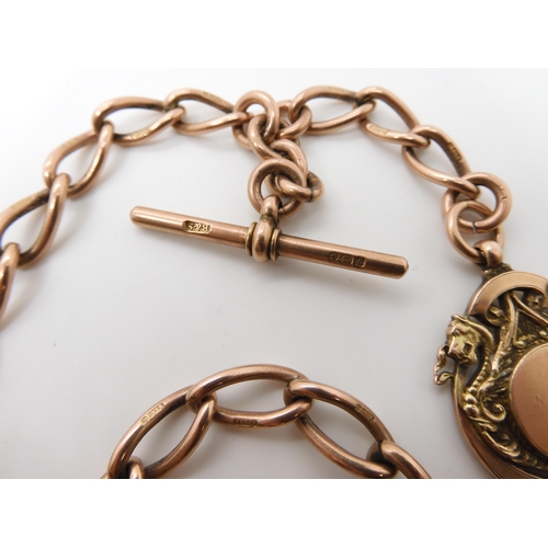 630 - A 9CT ROSE GOLD TAPERED FOB CHAIN WITH DRAGON MEDALLION