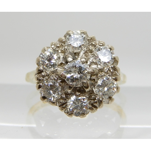 641 - AN 18CT GOLD DIAMOND FLOWER RING