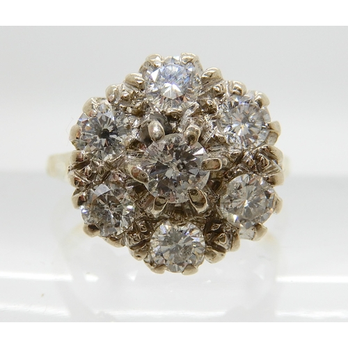 641 - AN 18CT GOLD DIAMOND FLOWER RING