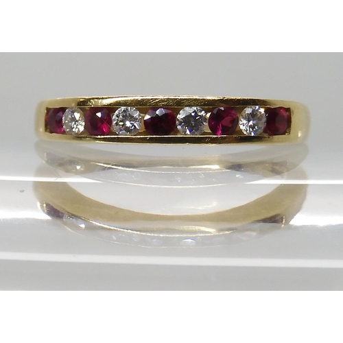 648 - AN 18CT RUBY AND DIAMOND HALF ETERNITY RING