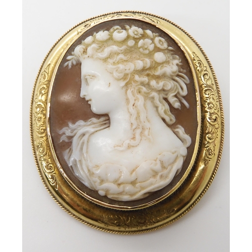 651 - A YELLOW METAL MOUNTED SHELL CAMEO BROOCH OF A MAIDEN