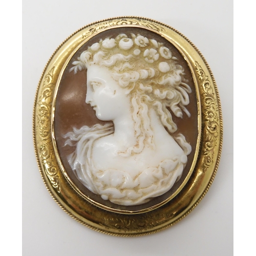 651 - A YELLOW METAL MOUNTED SHELL CAMEO BROOCH OF A MAIDEN