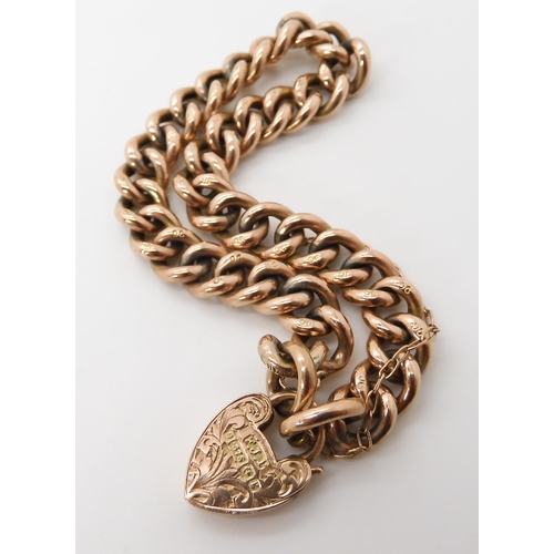 662 - A 9CT GOLD CURB CHAIN BRACELET WITH HEART SHAPED CLASP